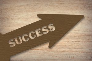 Success carved into an arrow because that's what marketing will bring to your business