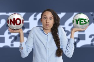 Woman holding a no and a yes ball confused about soft opt-in for GDPR and marketing