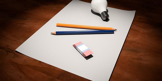 Picture of blank paper, pens and a lightbulb to help you get creative with building your business brand