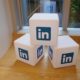 Giant building blocks with the LinkedIn logo because LinkedIn is great for building your business presence online