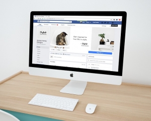 Picture of a mac on a desk being used to manage a facebook business page