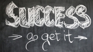"success go get it" written on a blackboard with chalk to demonstrate a call to action