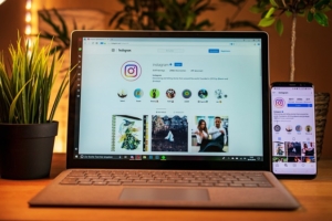 Picture of a laptop and phone open on Instagram to watch some reels