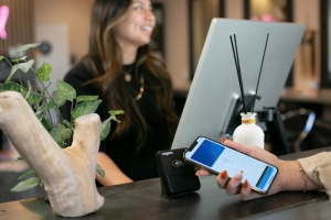 A socila media follower paying for an item with their phone
