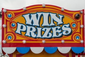 Pictutre of a fairground sign that says 'win prizes'